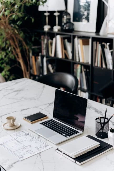 Minimalist desk with a focus on a multipurpose cleaner, office supplies, and storage solutions.